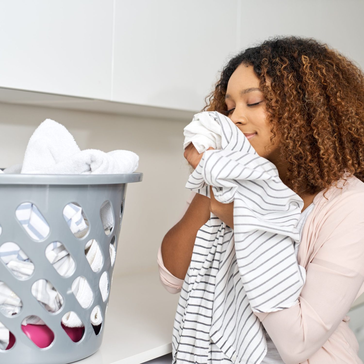Shot of a young attractive woman doing laundry at home.